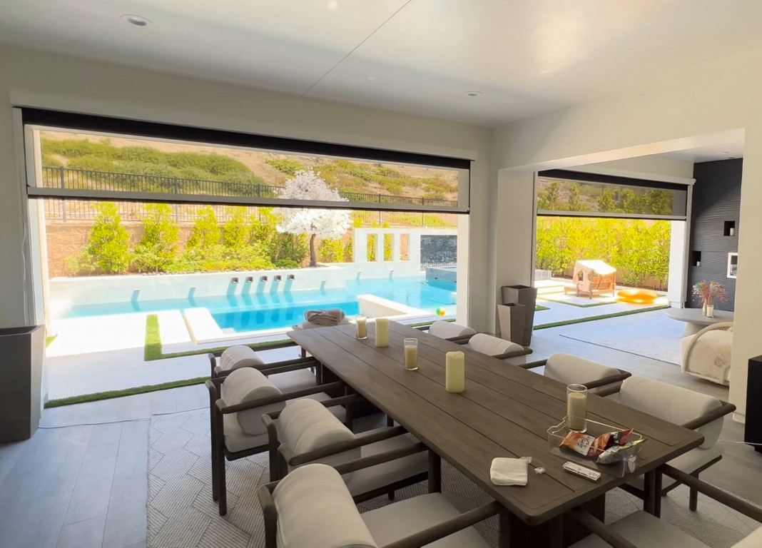 Luxury sunroom interior with energy-efficient glass and poolside view